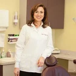 Dr. Inna Dunker in a white coat in a treatment room